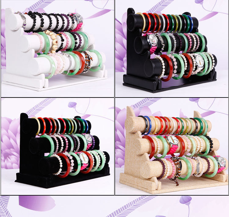 Close-up of watches and bracelets displayed on velvet stand