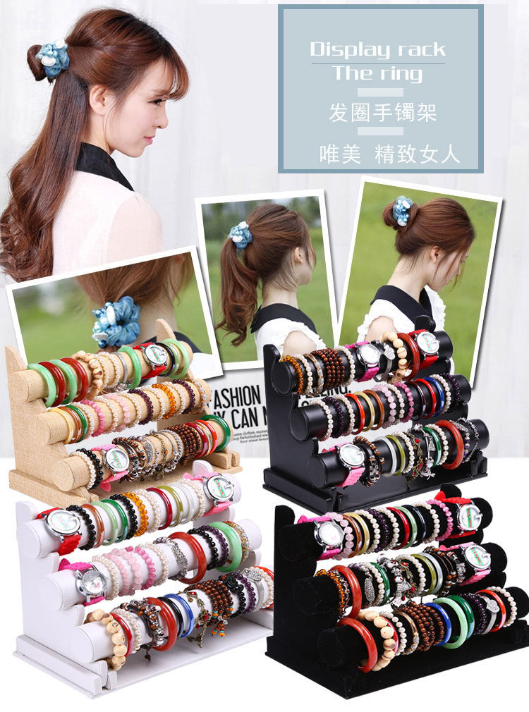 Close-up of watches and bracelets displayed on velvet stand