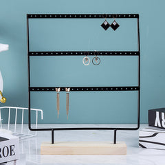 Close-up of Metal Earring Holder with Wooden Base - Image 2