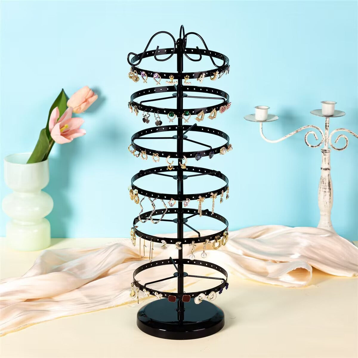 Elegant rotating earring organiser with black earrings displayed
