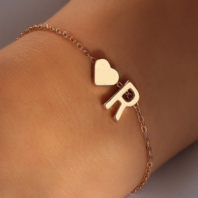 Fashionable gold letter bracelet on model