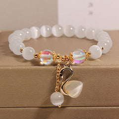 Close-up of cat's eye beaded bracelet on display
