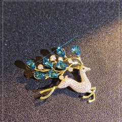 Elegant blue crystal deer brooch on display