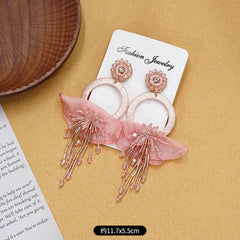 Different colour options of floral earrings presented
