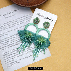 Close-up of intricate design detail on tassel earrings