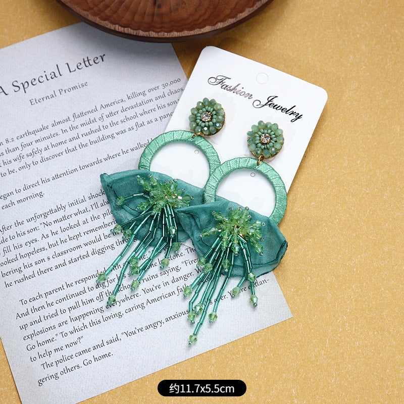 Close-up of intricate design detail on tassel earrings