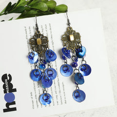 Colorful long tassel earrings displayed on a model