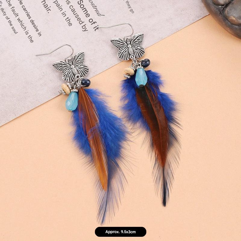 Artistic feather earrings on display image 8
