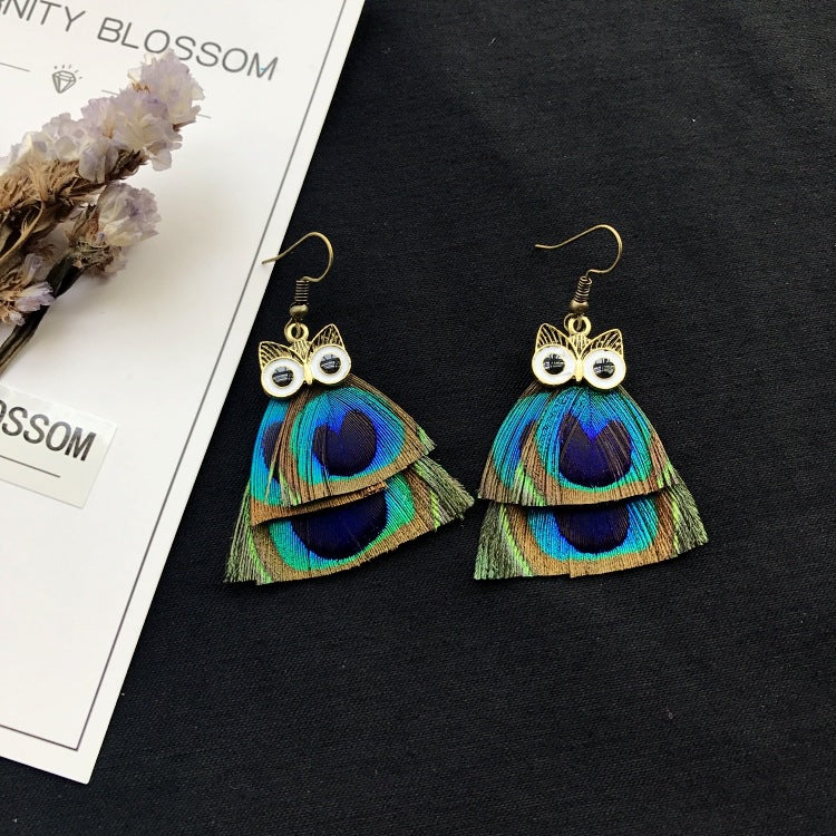 Close-up of colourful feather earrings image 2
