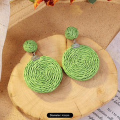 Elegant woven rattan earrings on display