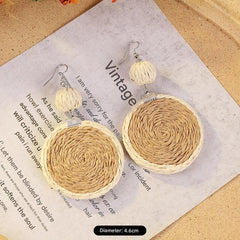 Elegant woven rattan earrings on display