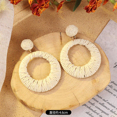 Elegant woven rattan earrings on display