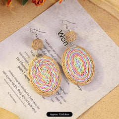 Elegant woven rattan earrings on display