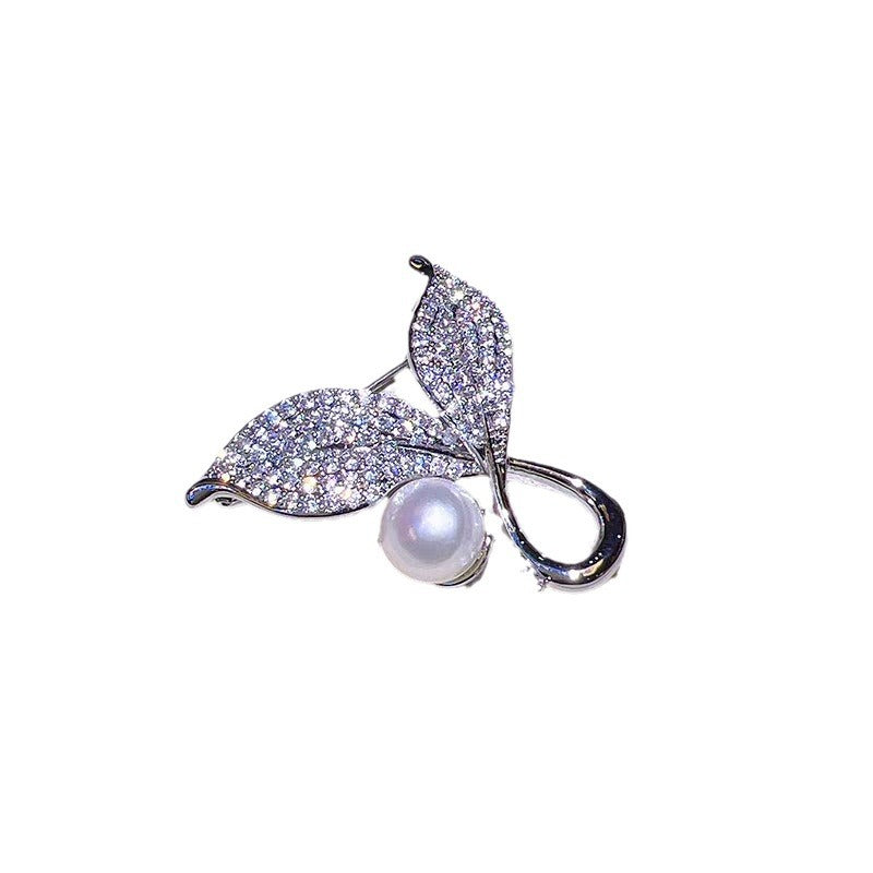 Brooch displayed against a soft fabric background