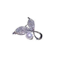 Brooch displayed against a soft fabric background