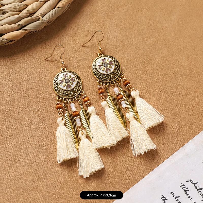 model wearing vintage style feather earrings