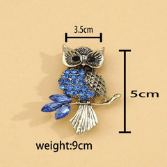 Close-up of crystal owl brooch