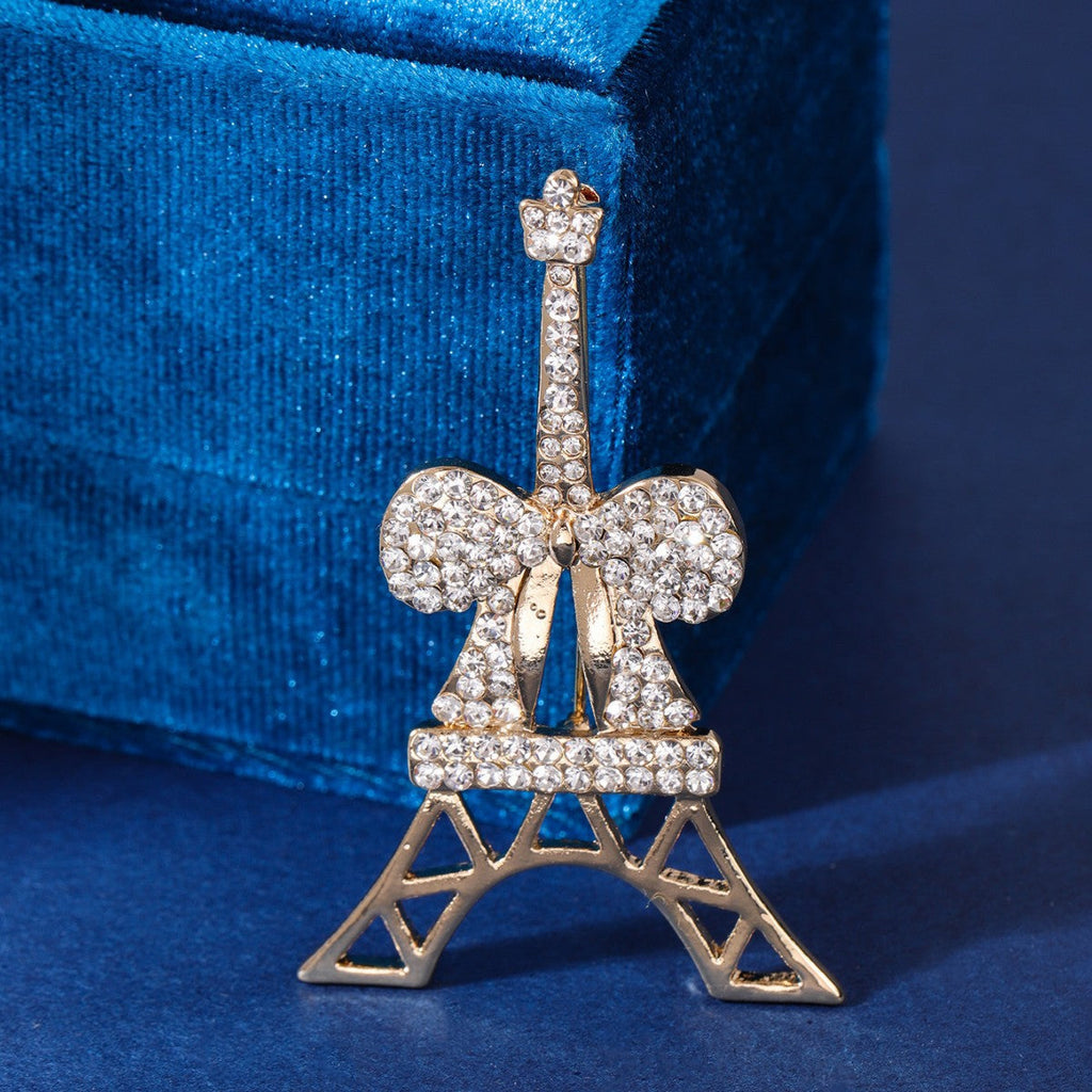 Elegant Eiffel Tower brooch displayed on fabric