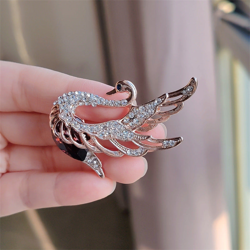 Close-up of Crystal-accented Swan Brooch for women
