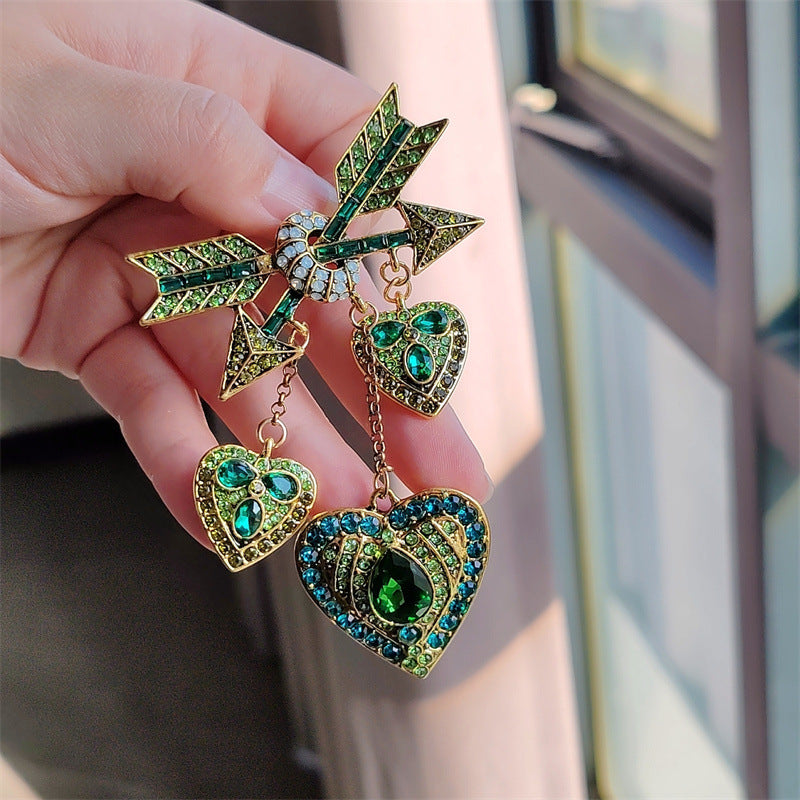 Close view of the colourful Cupid heart arrow brooch