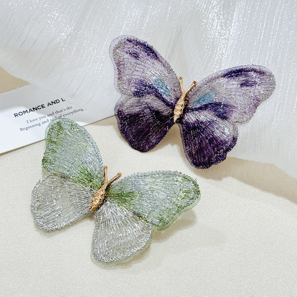 Close-up view of embroidered butterfly brooch