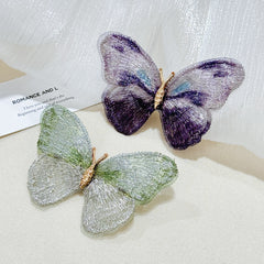 Close-up view of embroidered butterfly brooch