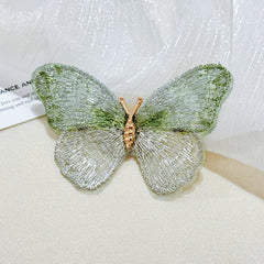 Embroidered butterfly pin on dress
