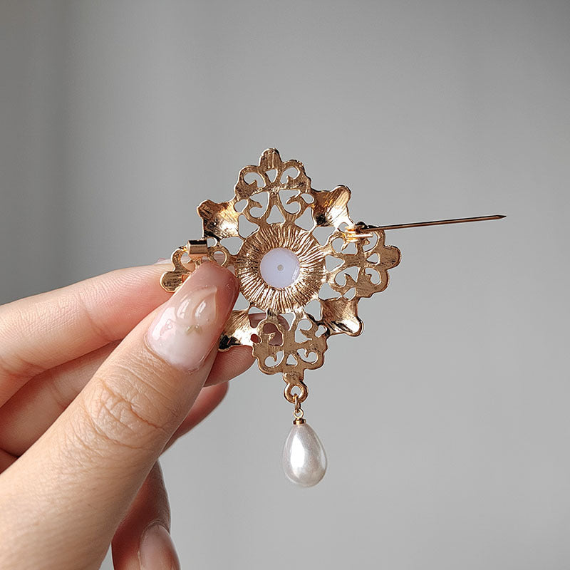 Elegant vintage-inspired pearl brooch on a model