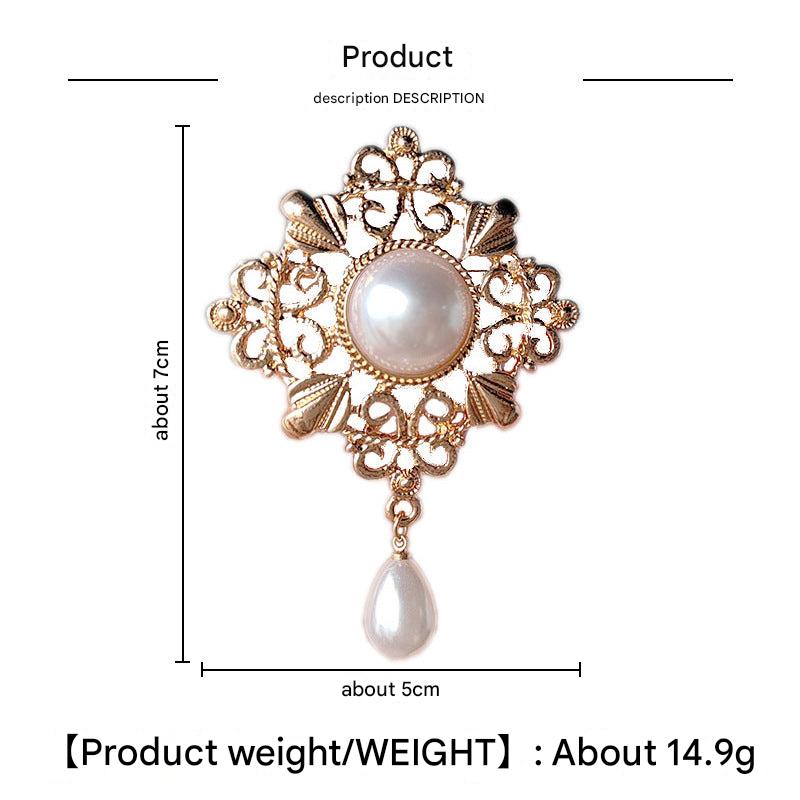 An ornamental brooch featuring pearl accents