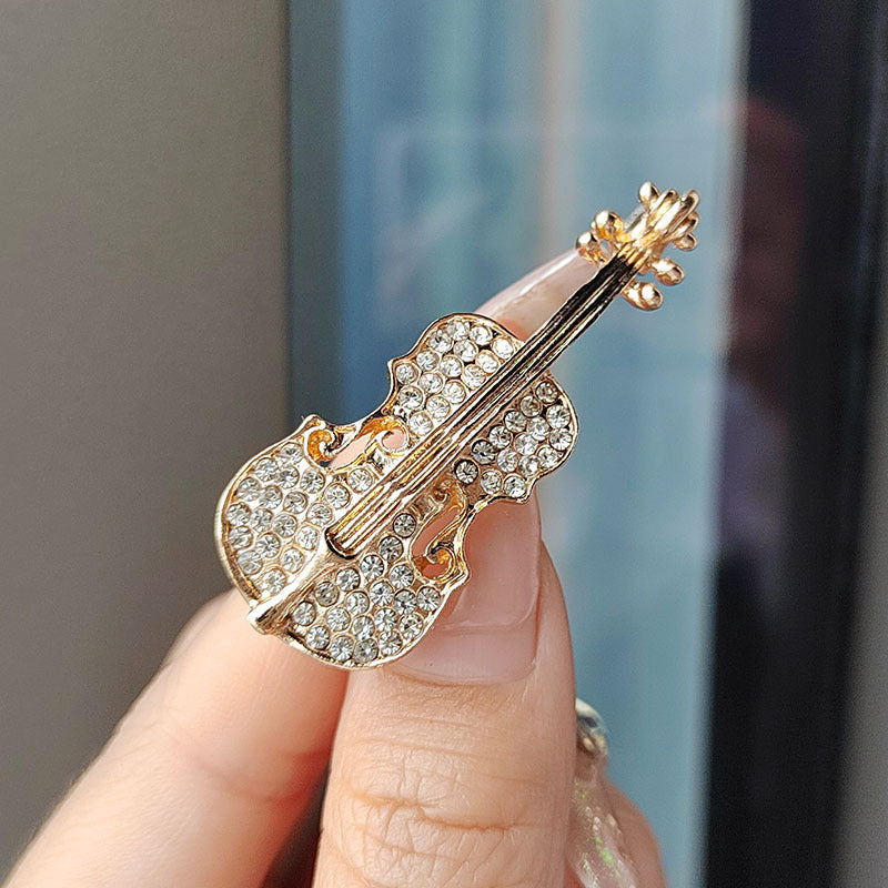 Gold oil drop violin brooch showcasing sparkling rhinestones