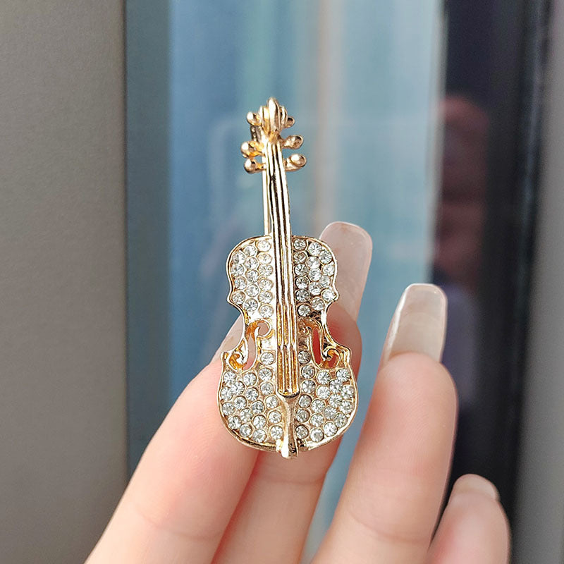 Additional angle of gold brooch with pearl detail