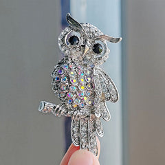 Close-up of crystal details in owl brooch