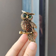 Elegant owl brooch on scarf showcasing its design
