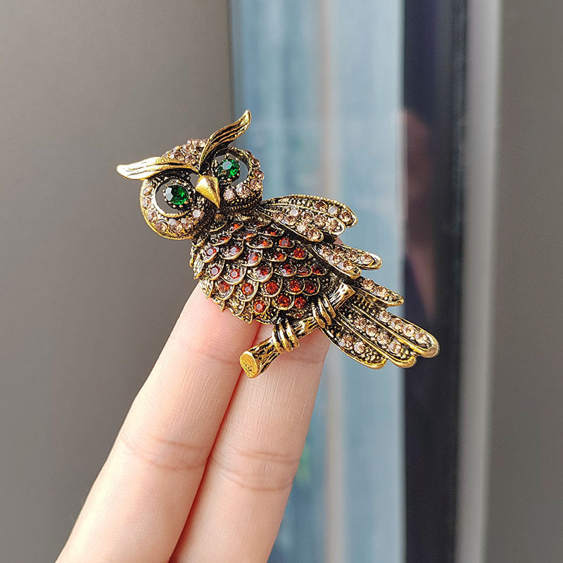 Elegant owl brooch laid out flat for display