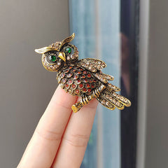 Elegant owl brooch laid out flat for display