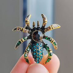 Stylish spider brooch on a blue background