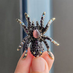 Deep purple spider brooch displayed elegantly