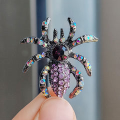 Champagne-coloured spider brooch against white