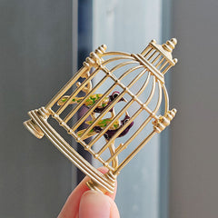 Stylish unisex birdcage brooch on a suit