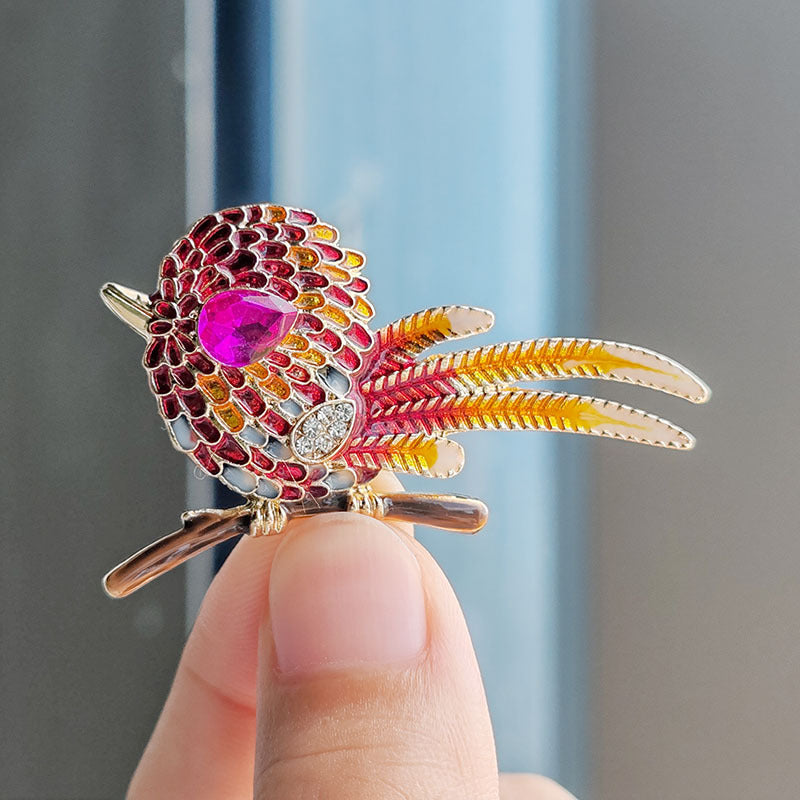 Close-up of colourful bird brooch with rhinestones