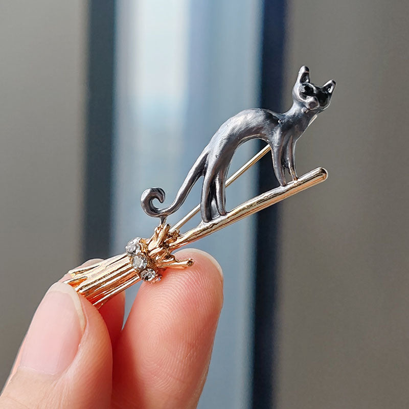 Close up of the gold cat brooch showcasing unique design
