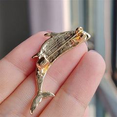 Close-up of the stylish dolphin brooch with electroplated finish