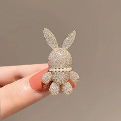 gold bunny brooch alongside other jewellery