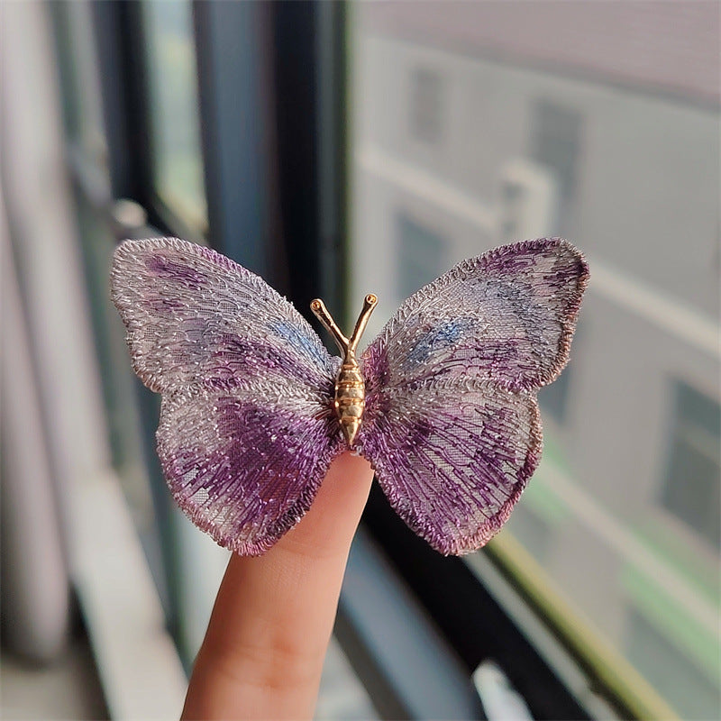 Whimsical butterfly embroidered brooch in purple