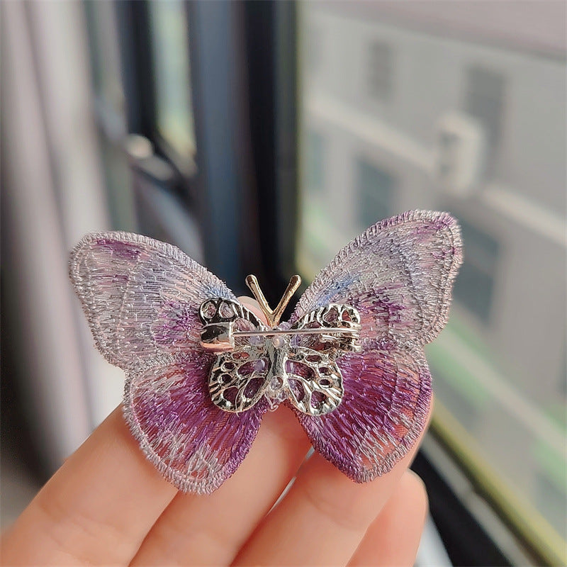 Green butterfly embroidered brooch displayed