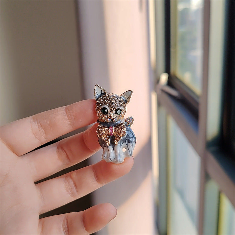 Close-up of the cat-themed brooch design