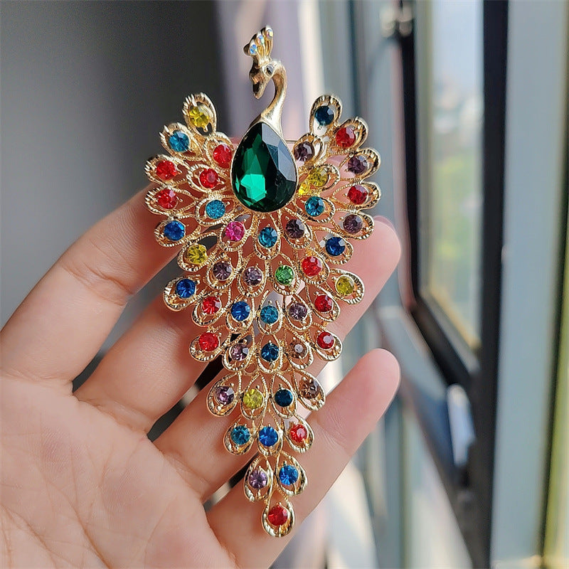Peacock brooch highlighting rhinestones