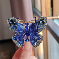 Red crystal butterfly brooch displayed on white background
