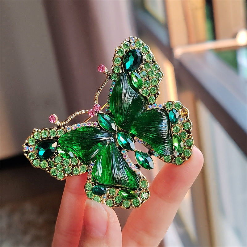 Red crystal butterfly brooch displayed on white background