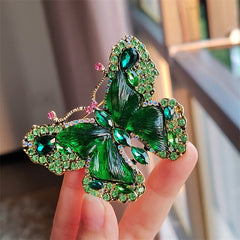Red crystal butterfly brooch displayed on white background